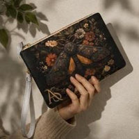 Load image into Gallery viewer, Gothic Cottagecore Wristlet Vintage Moth Illustration Clutch Botanical Floral Print Vegan Leather Zippered Pouch Makeup Bag Travel Organizer Phone Wallet Card Holder Dark Aesthetic Gift Nature Inspired Cosmetics Storage Gold Hardware Design